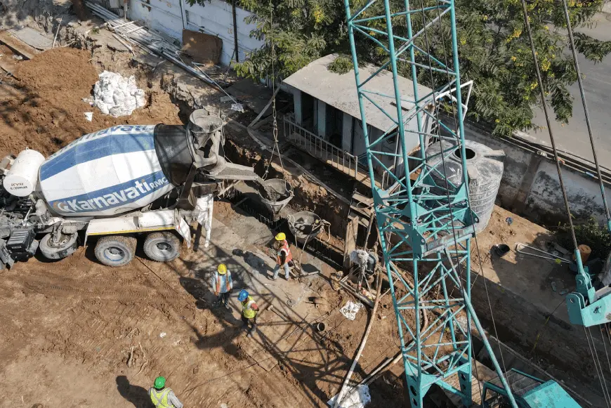 A top shot of a diaphragm wall construction site, with concrete being poured in the trench